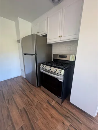 a kitchen with a stove and a refrigerator