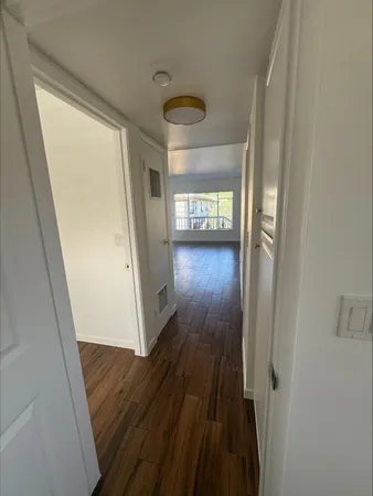 a view of a hallway and wooden floor