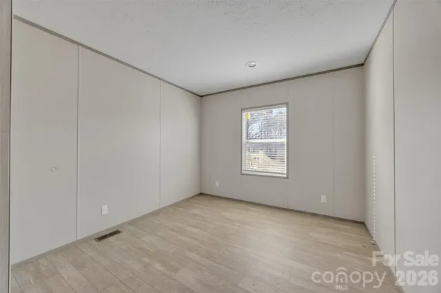 an empty room with a empty space and windows