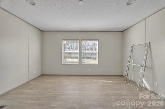 a front view of a house with a yard covered in snow