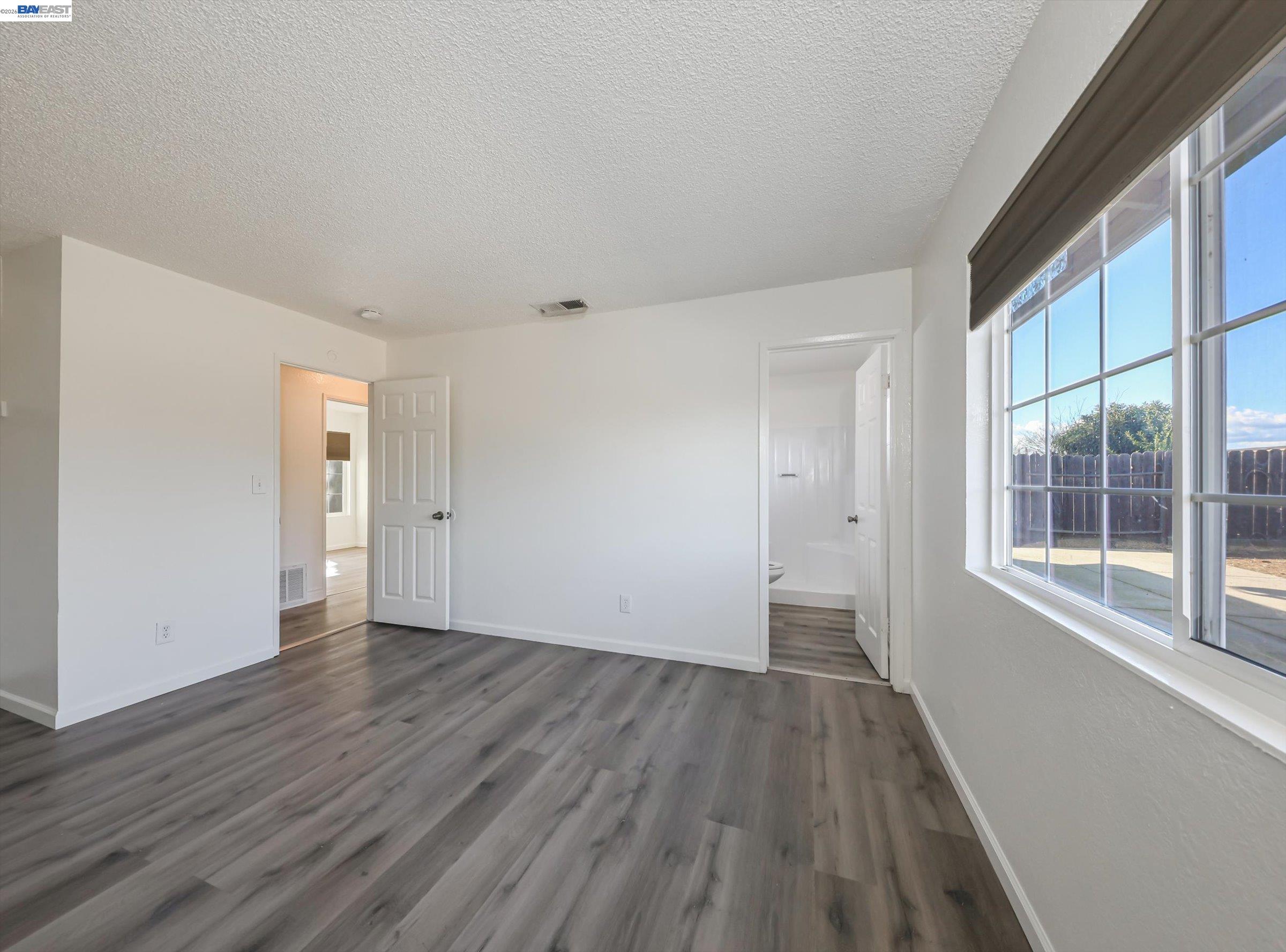 3432 Danielle Place Bay Point, CA 94565 - Photo 23 of 36 a view of an empty room with wooden floor and a window