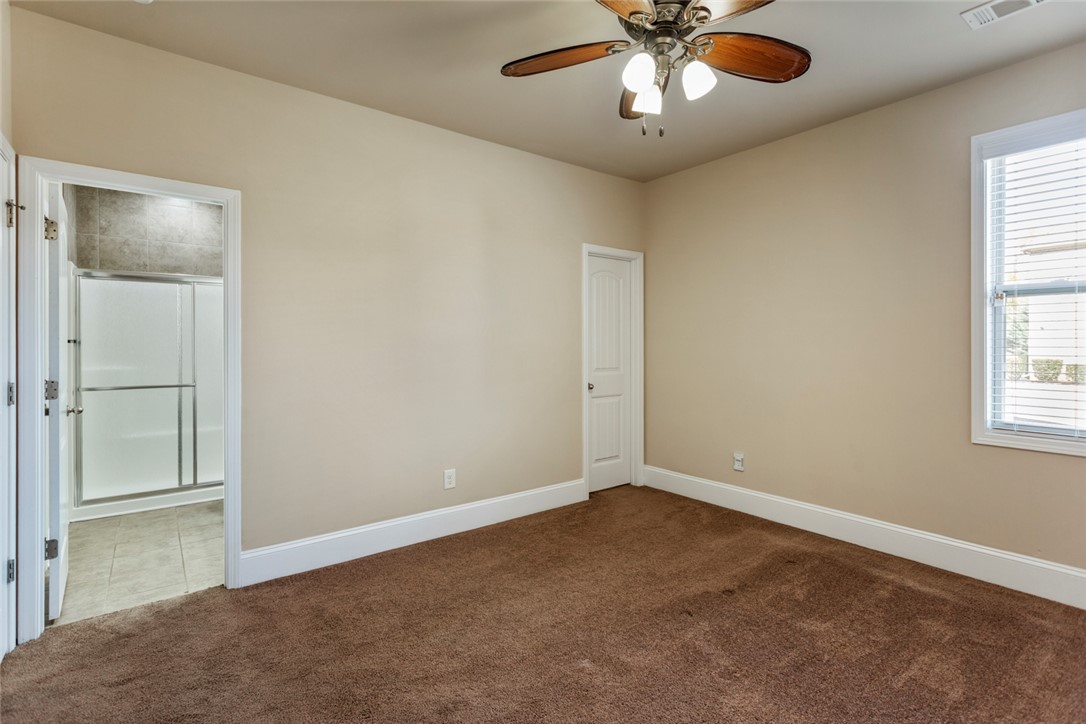1005 Winmar Drive Anderson, SC 29621 - Photo 23 of 50 This spacious bedroom offers comfortable carpeting and a bright window, with an adjoining bathroom.
