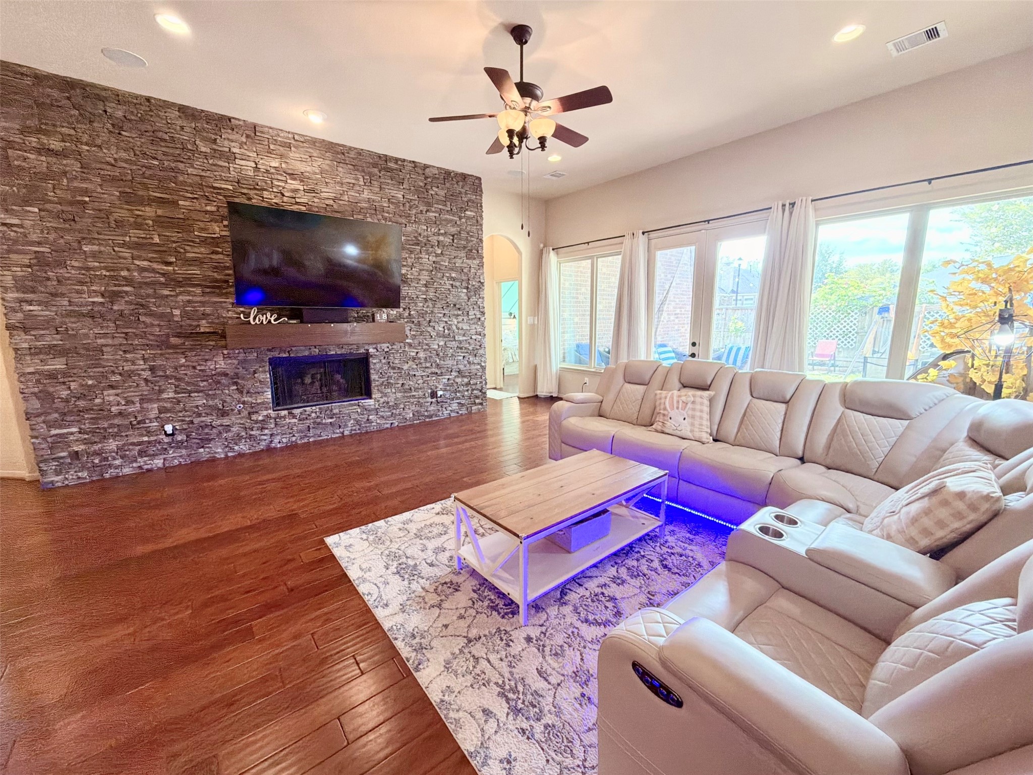 29011 Powder Ridge Drive Katy, TX 77494 - Photo 11 of 25 a living room with furniture a flat screen tv and a fireplace