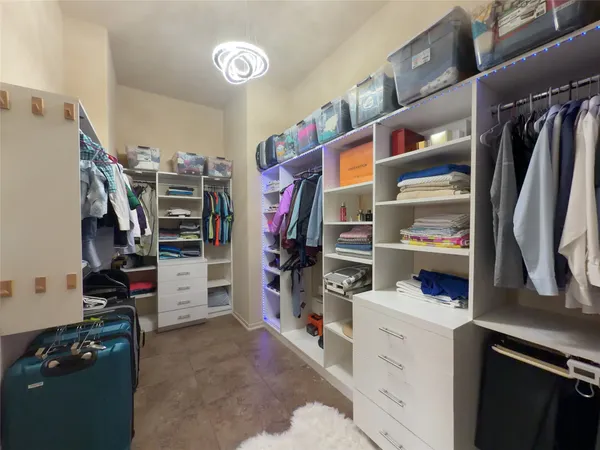 a view of walk in closet with living room