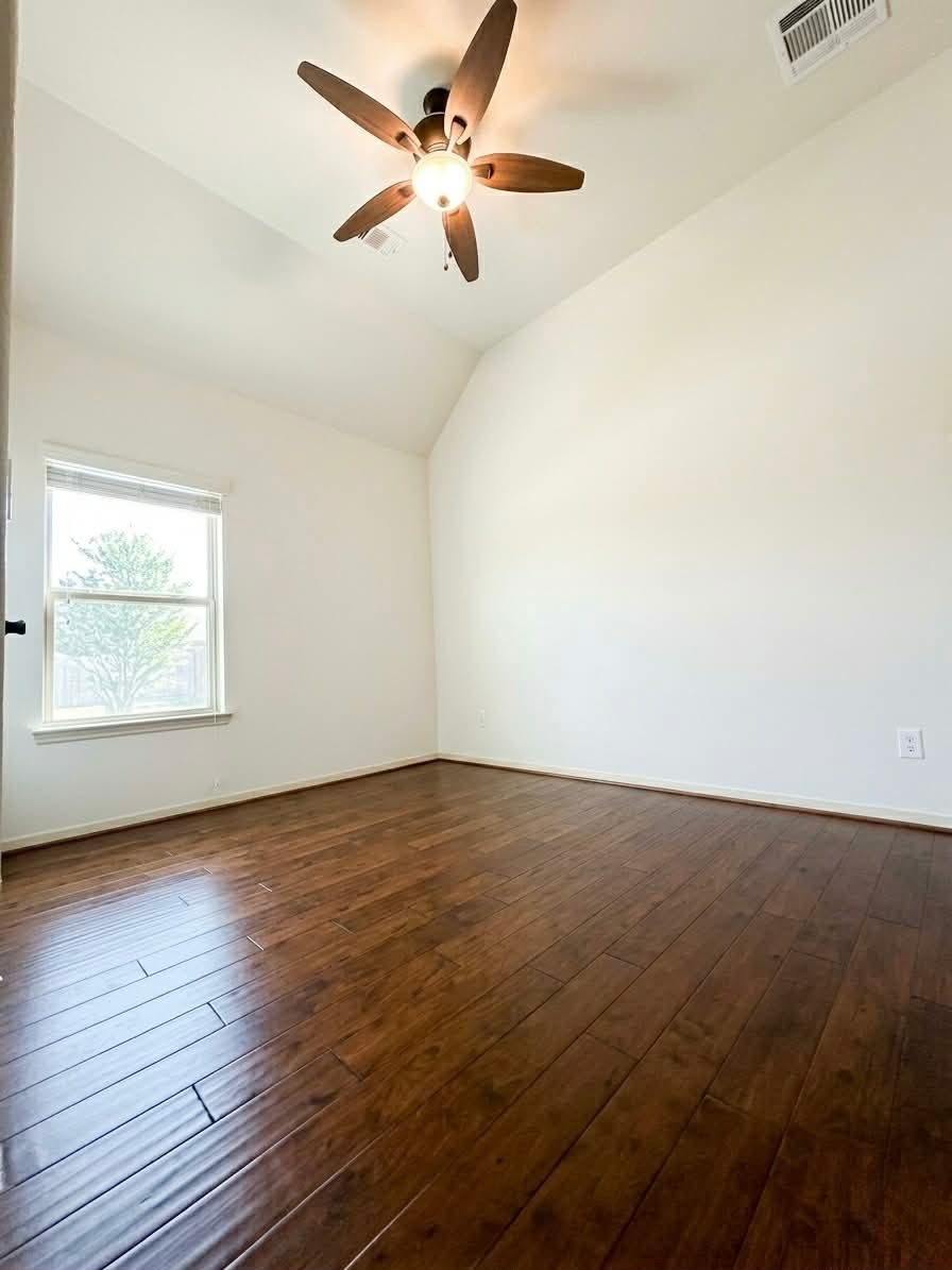 29011 Powder Ridge Drive Katy, TX 77494 - Photo 20 of 25 an empty room with wooden floor fan and windows