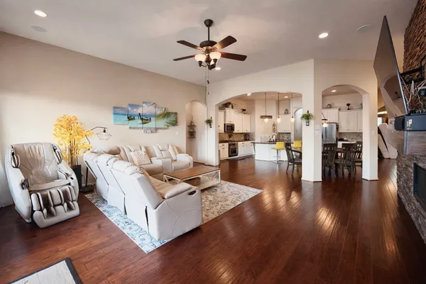 a living room with furniture a flat screen tv and a fireplace