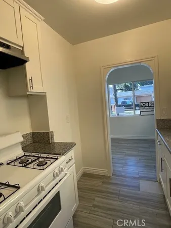 a stove top oven sitting inside of a kitchen