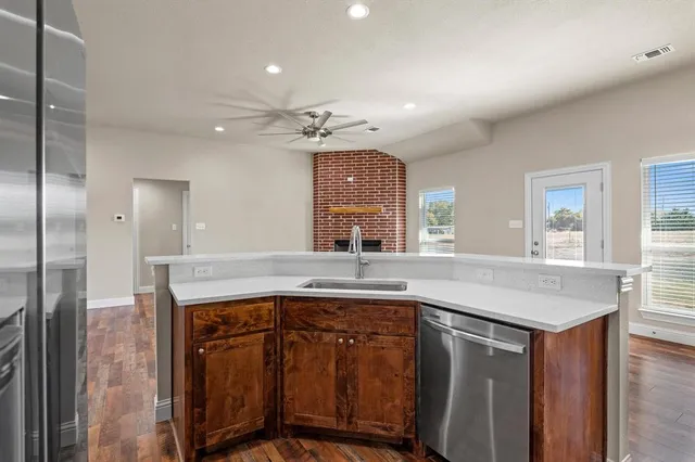 a kitchen with a sink a counter space and stainless steel appliances