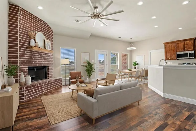 a living room with furniture a fireplace and a flat screen tv