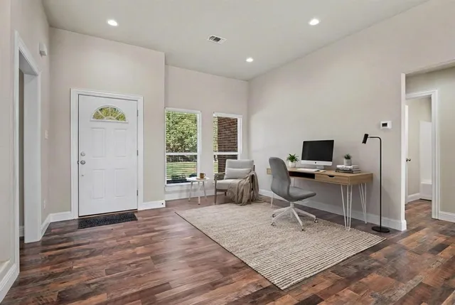 a workspace with wooden floor and a window
