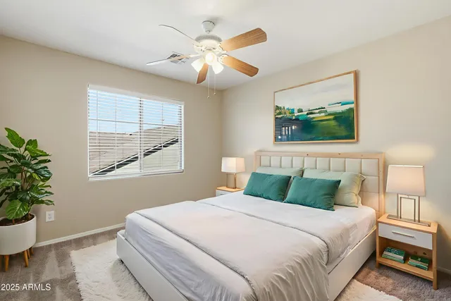a bedroom with bed and wooden floor