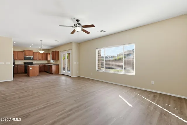 a view of a room with a kitchen and a window