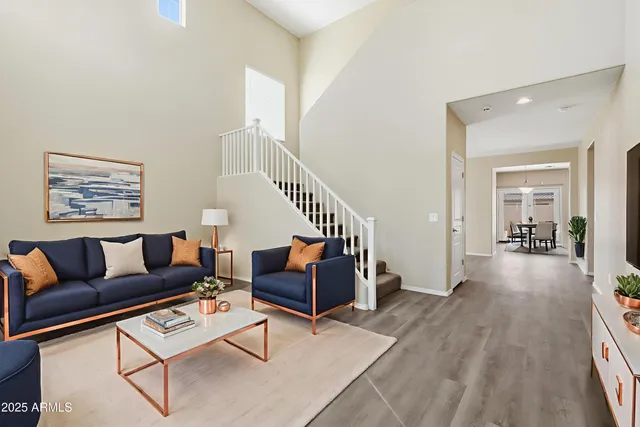 a living room with furniture and wooden floor