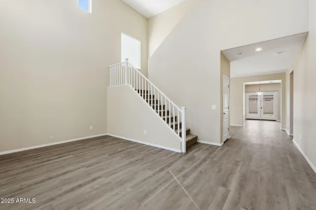 a view of a hallway with wooden floor and entryway
