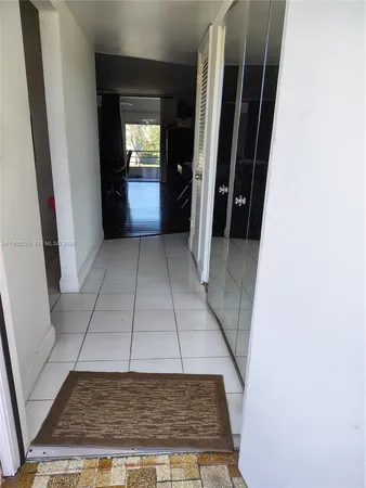 a living room with furniture hard wood floor and a flat screen tv