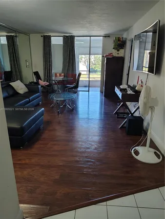 a living room with furniture rug and wooden floor