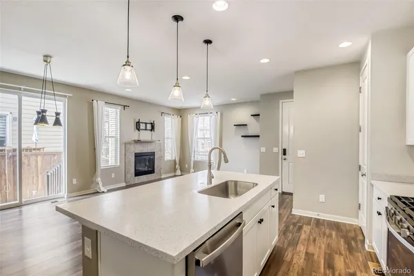 a view of a dining room with furniture a rug and wooden floor