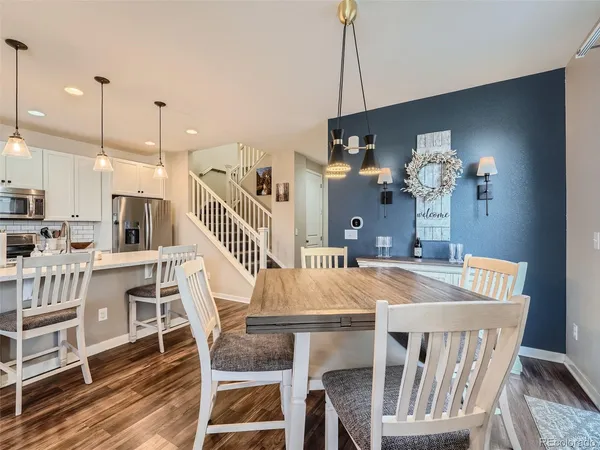 a kitchen view with wooden floor and electronic appliances