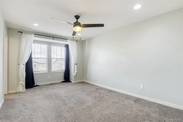 a bedroom with a bed a lamp and a chandelier