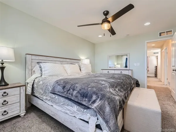 a bathroom with a shower sink vanity mirror and toilet