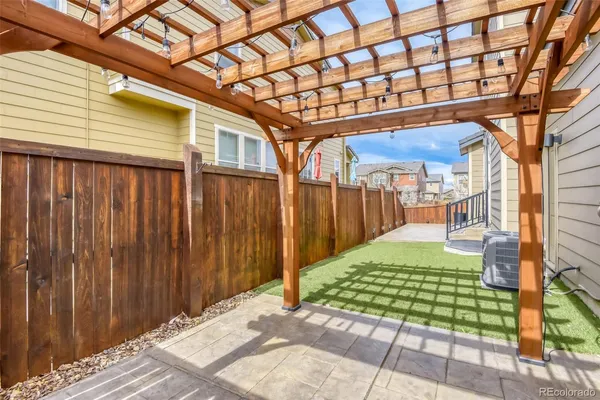 a view of a back yard with patio
