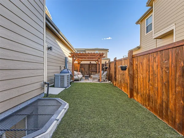a view of a house with a small yard and a patio