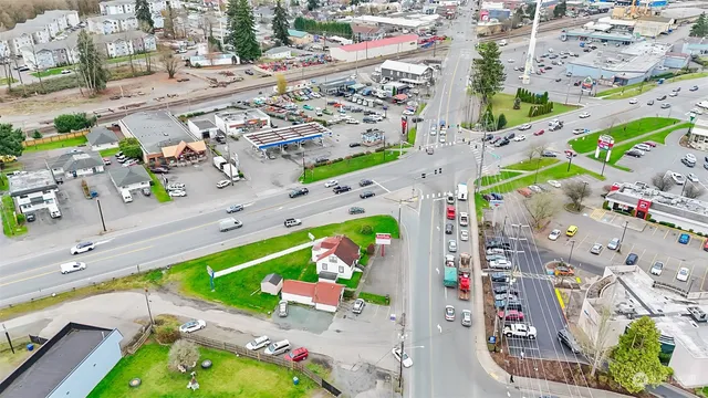 an aerial view of a house with a garden and swimming pool
