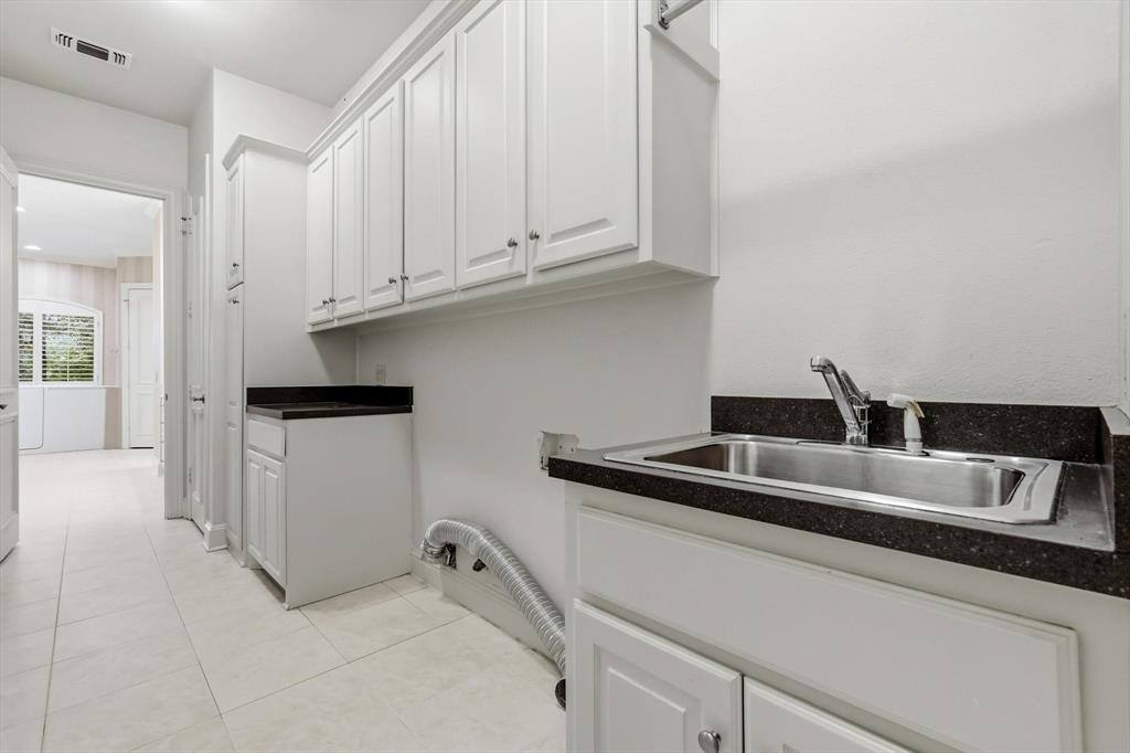 970 Crystal Cove Oak Point, TX 75068 - Photo 17 of 40 a kitchen with stainless steel appliances granite countertop a sink and dishwasher with white cabinets