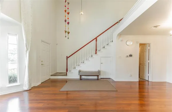 a view of entryway and hall with wooden floor