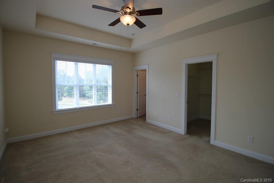 14058 Stumptown Road Huntersville, NC 28078 - Photo 12 of 14 an empty room with windows and fan