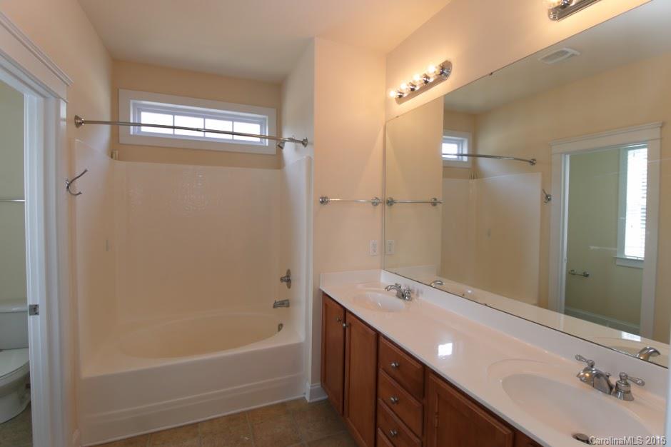 14058 Stumptown Road Huntersville, NC 28078 - Photo 13 of 14 a bathroom with a tub a sink and mirror