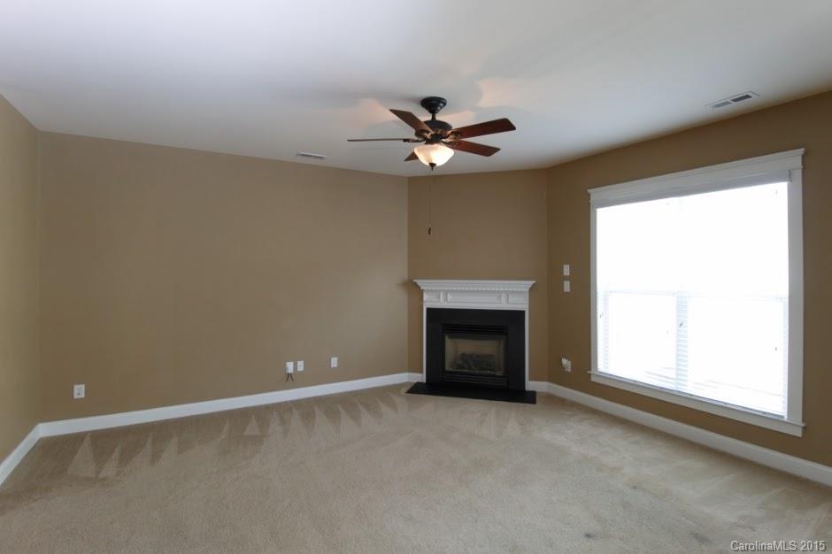 14058 Stumptown Road Huntersville, NC 28078 - Photo 3 of 14 an empty room with windows and fireplace