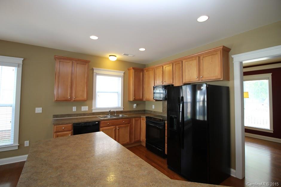 14058 Stumptown Road Huntersville, NC 28078 - Photo 5 of 14 a kitchen with stainless steel appliances granite countertop a refrigerator and a sink