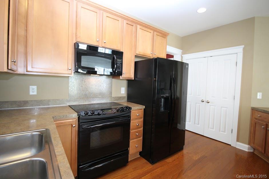 14058 Stumptown Road Huntersville, NC 28078 - Photo 6 of 14 a kitchen with stainless steel appliances a stove a microwave and a refrigerator