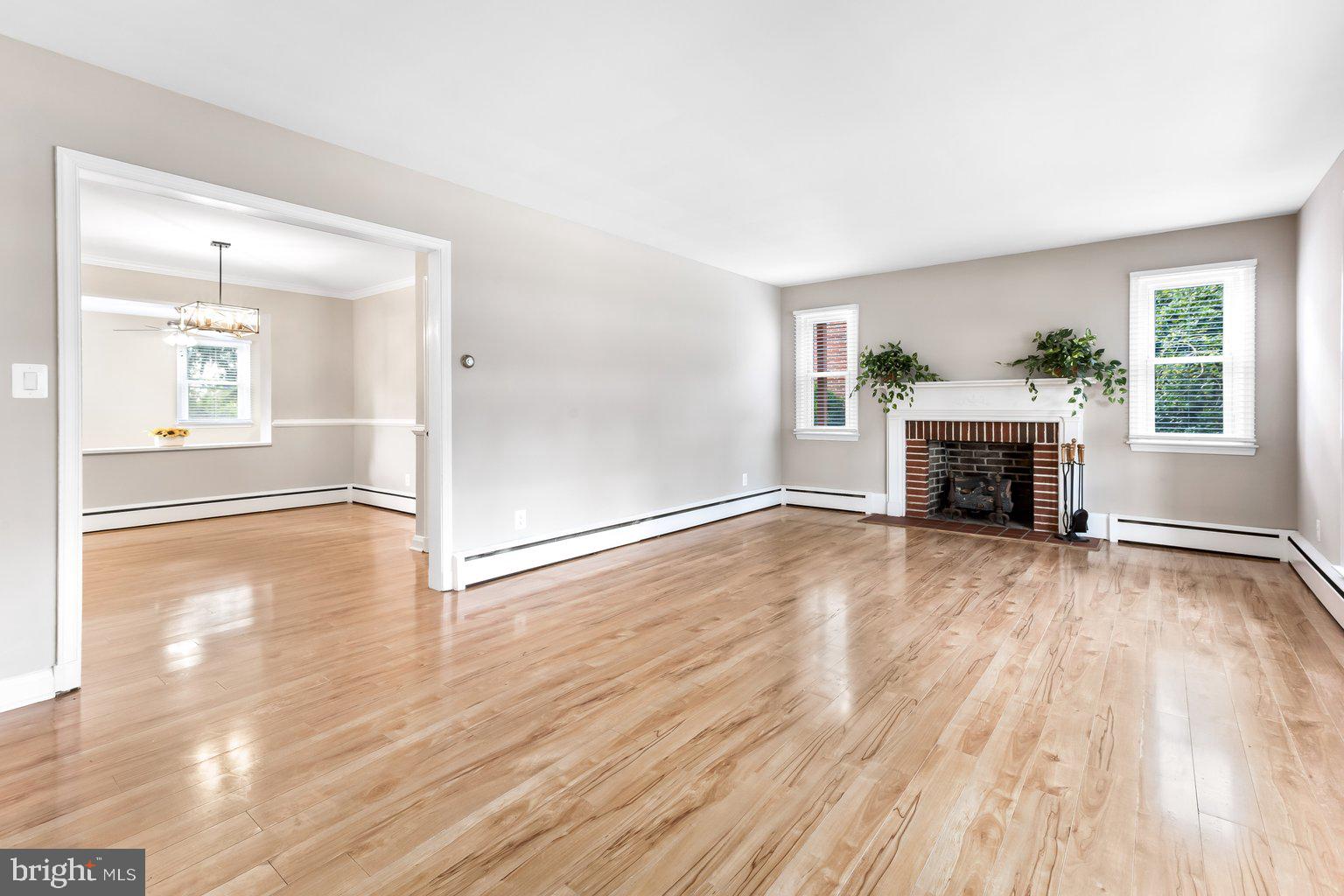 8335 Liberty Road Windsor Mill, MD 21244 - Photo 13 of 57 a view of empty room with wooden floor and fireplace