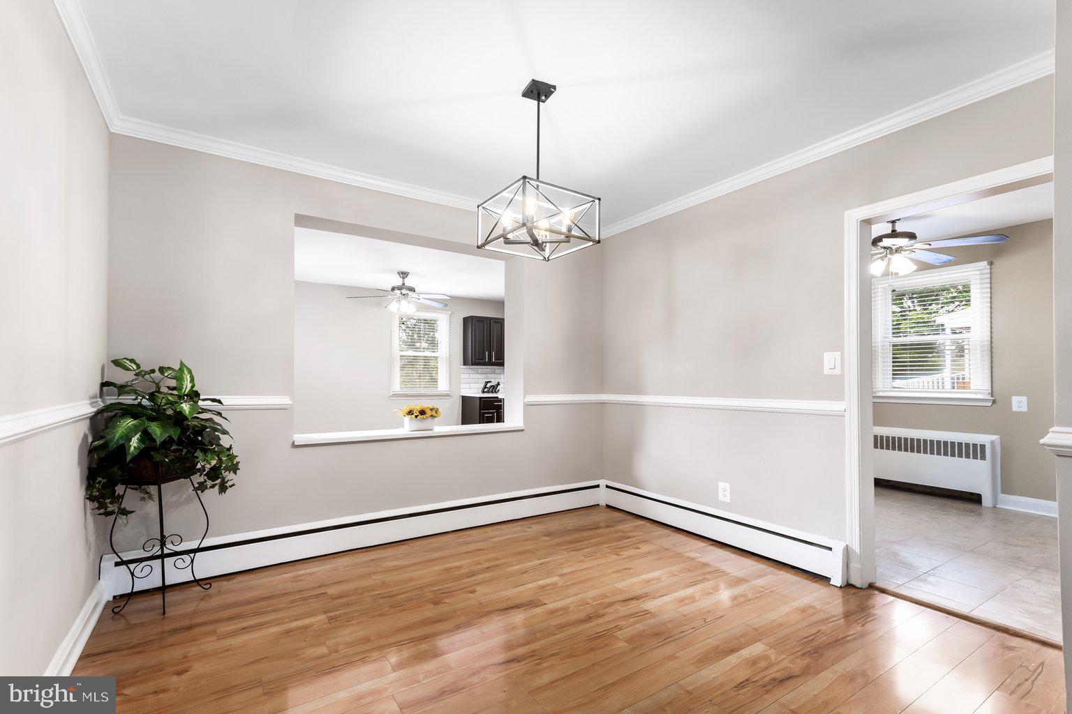 8335 Liberty Road Windsor Mill, MD 21244 - Photo 14 of 57 an empty room with wooden floor and windows