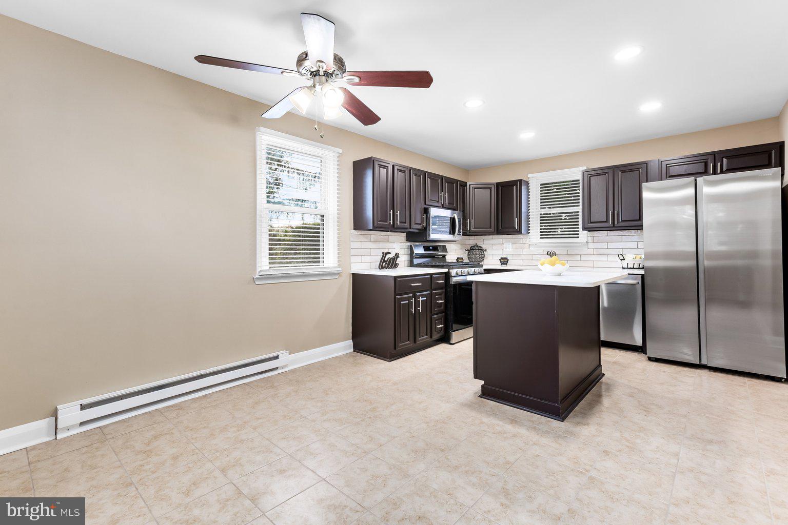 8335 Liberty Road Windsor Mill, MD 21244 - Photo 20 of 57 a kitchen with stainless steel appliances granite countertop a sink a stove a refrigerator cabinets and a window