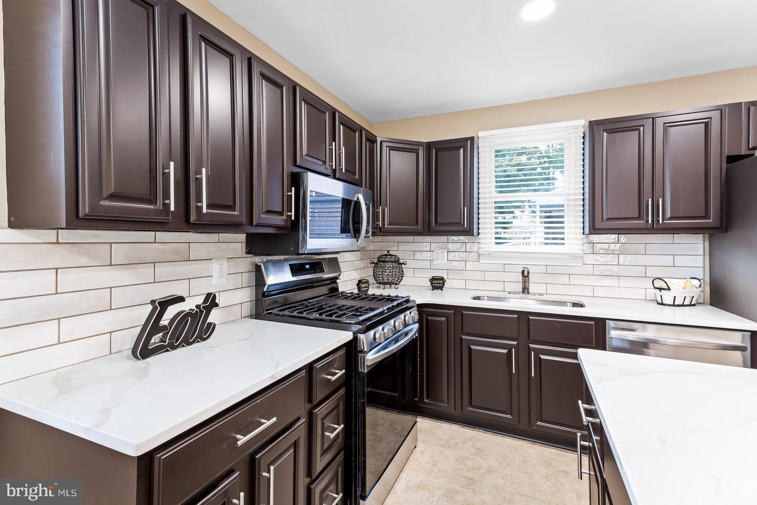 8335 Liberty Road Windsor Mill, MD 21244 - Photo 23 of 57 a kitchen with a sink stove top oven and cabinets