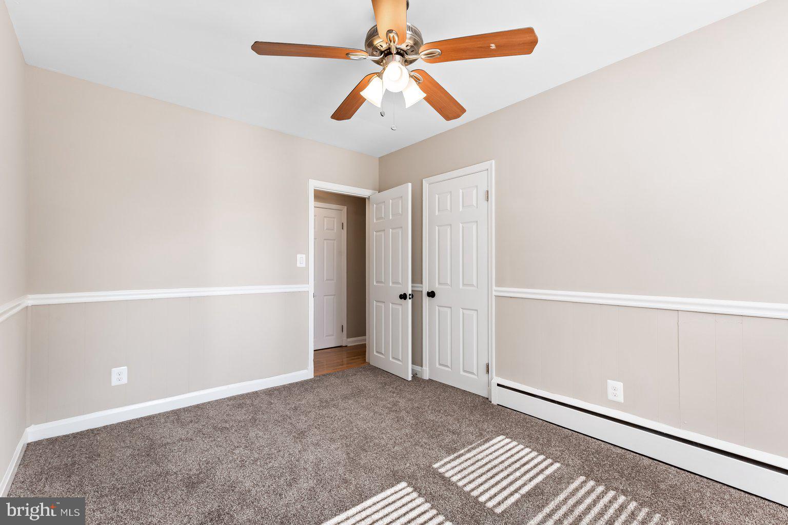 8335 Liberty Road Windsor Mill, MD 21244 - Photo 28 of 57 an empty room with closet and a chandelier fan