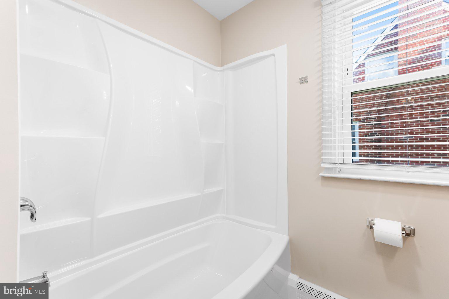 8335 Liberty Road Windsor Mill, MD 21244 - Photo 30 of 57 a white bath tub sitting next to a window