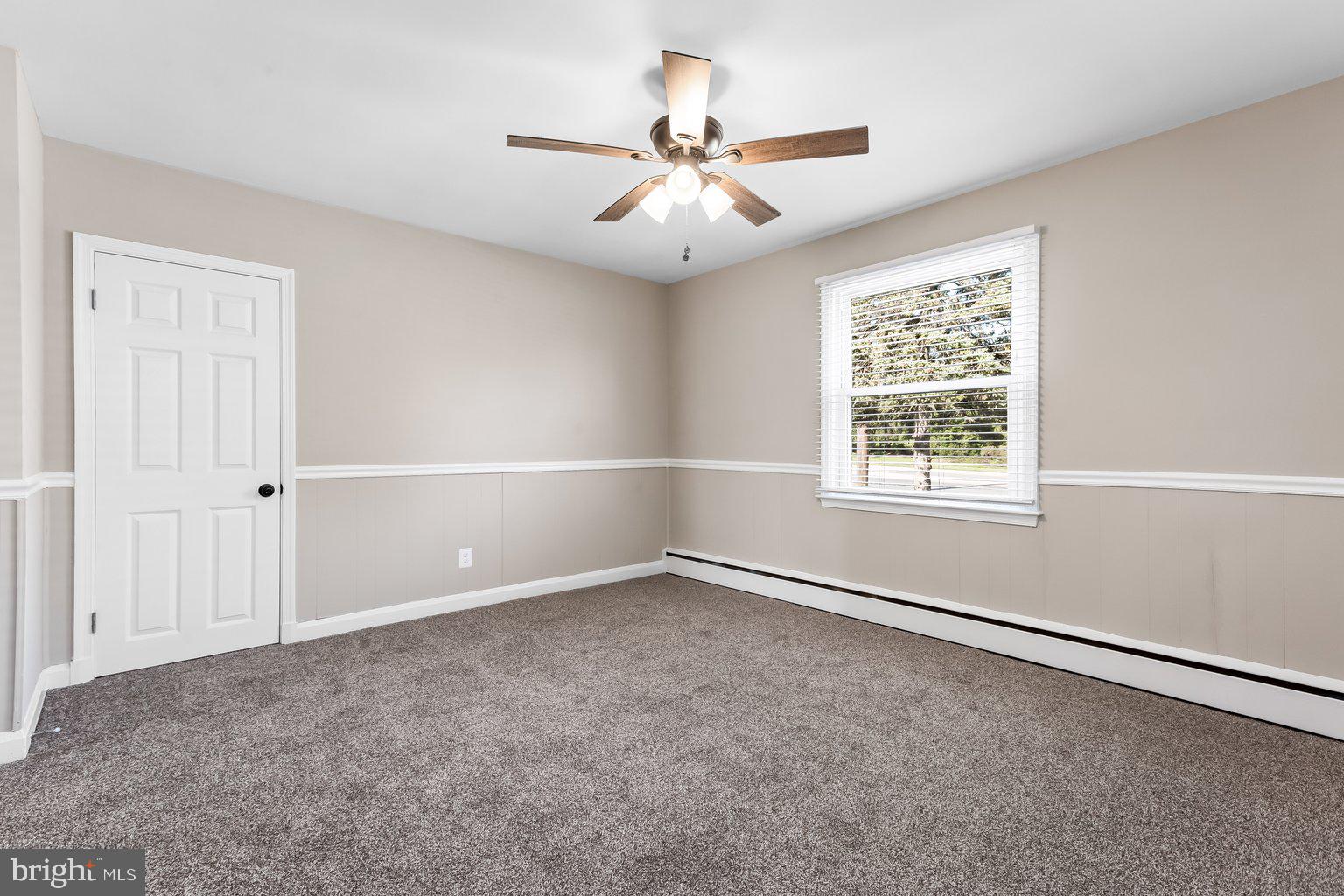 8335 Liberty Road Windsor Mill, MD 21244 - Photo 32 of 57 an empty room with a window and a fan