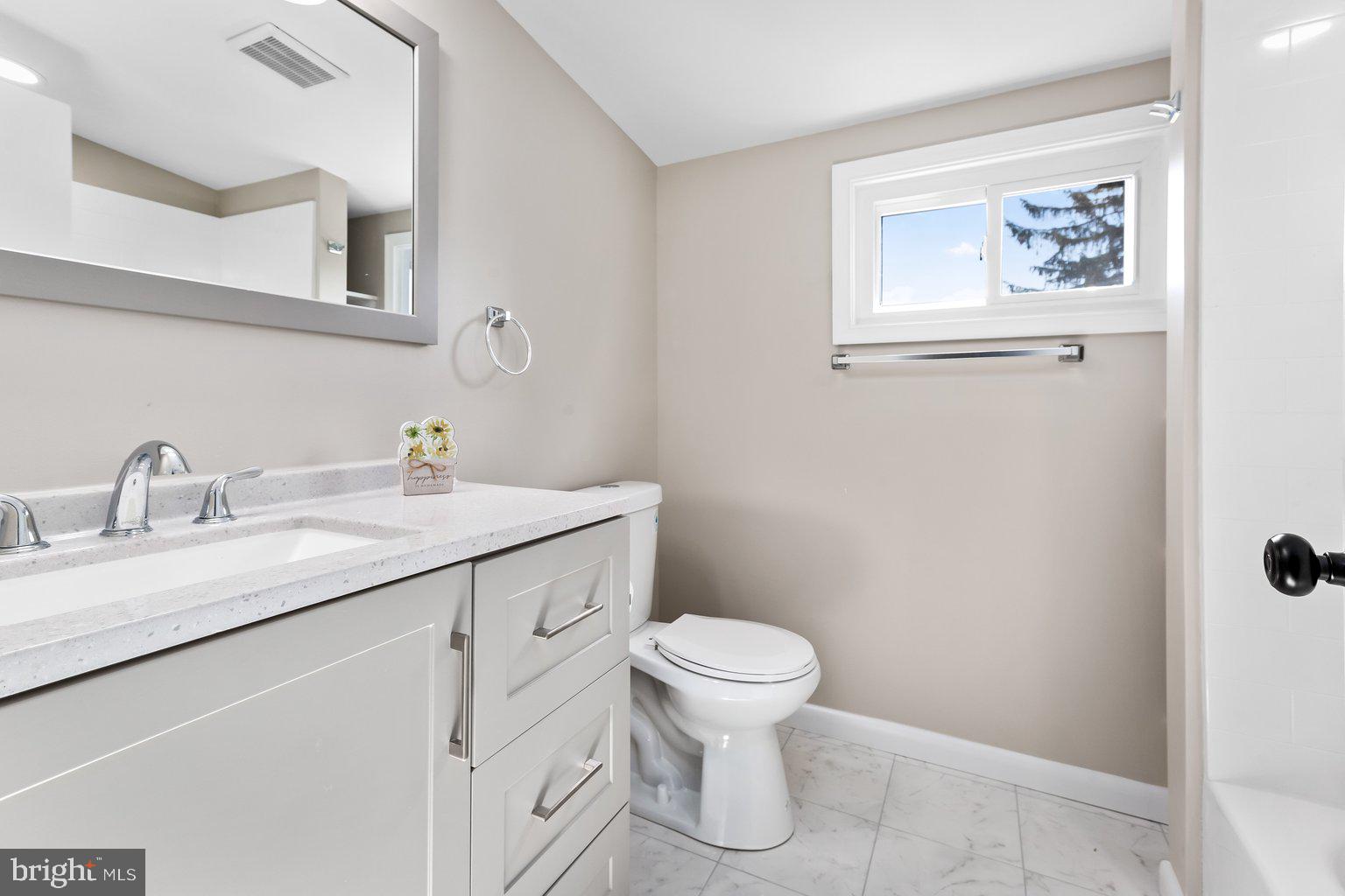 8335 Liberty Road Windsor Mill, MD 21244 - Photo 38 of 57 a bathroom with a toilet sink and mirror