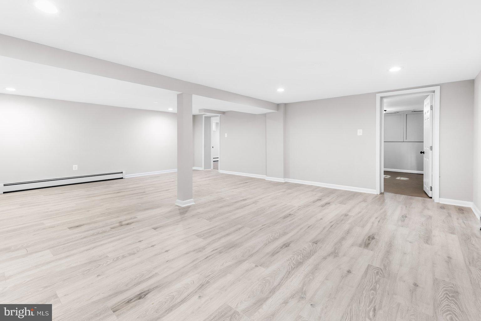 8335 Liberty Road Windsor Mill, MD 21244 - Photo 39 of 57 a view of an empty room with wooden floor