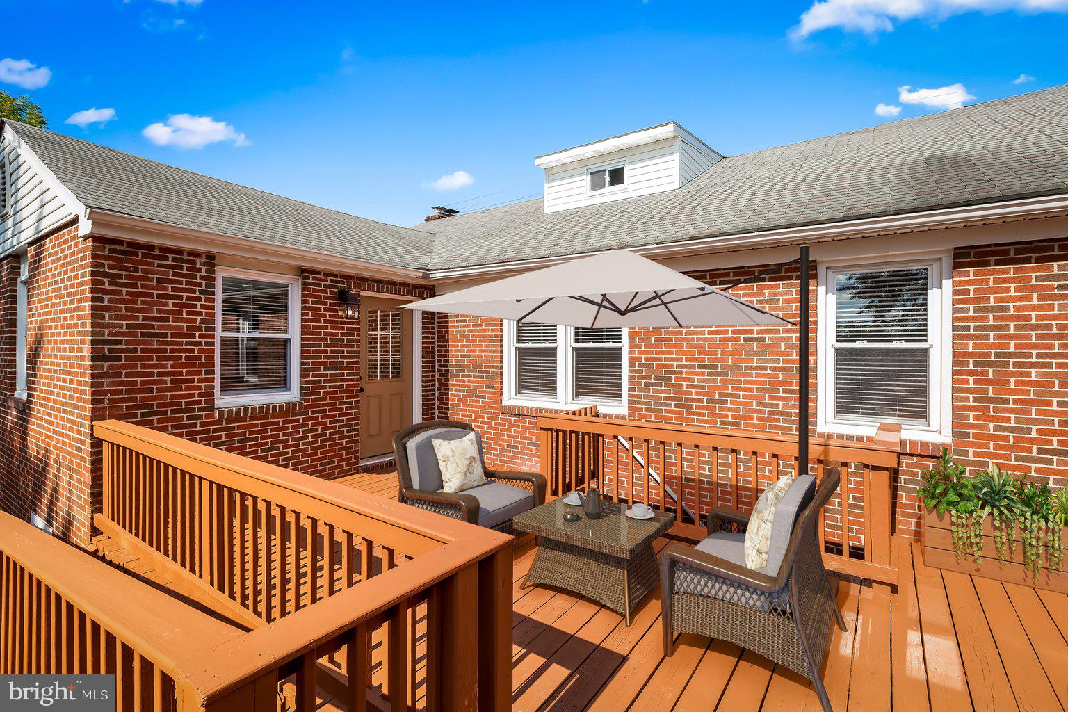 8335 Liberty Road Windsor Mill, MD 21244 - Photo 56 of 57 a view of a house with wooden deck and furniture