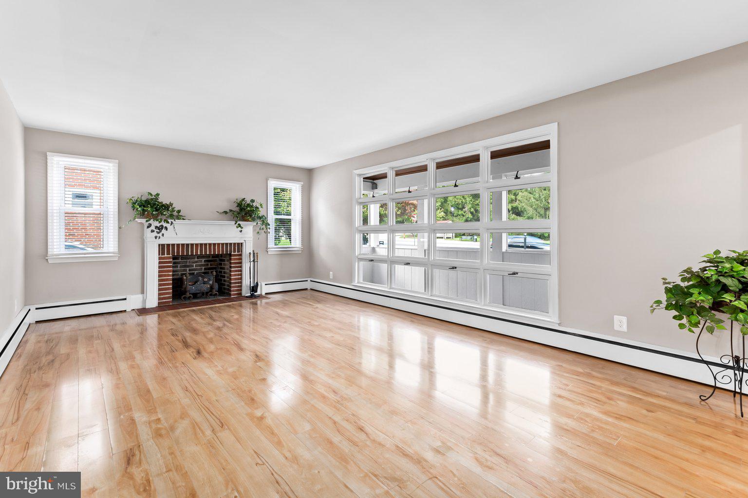 8335 Liberty Road Windsor Mill, MD 21244 - Photo 9 of 57 a view of empty room with wooden floor and fireplace