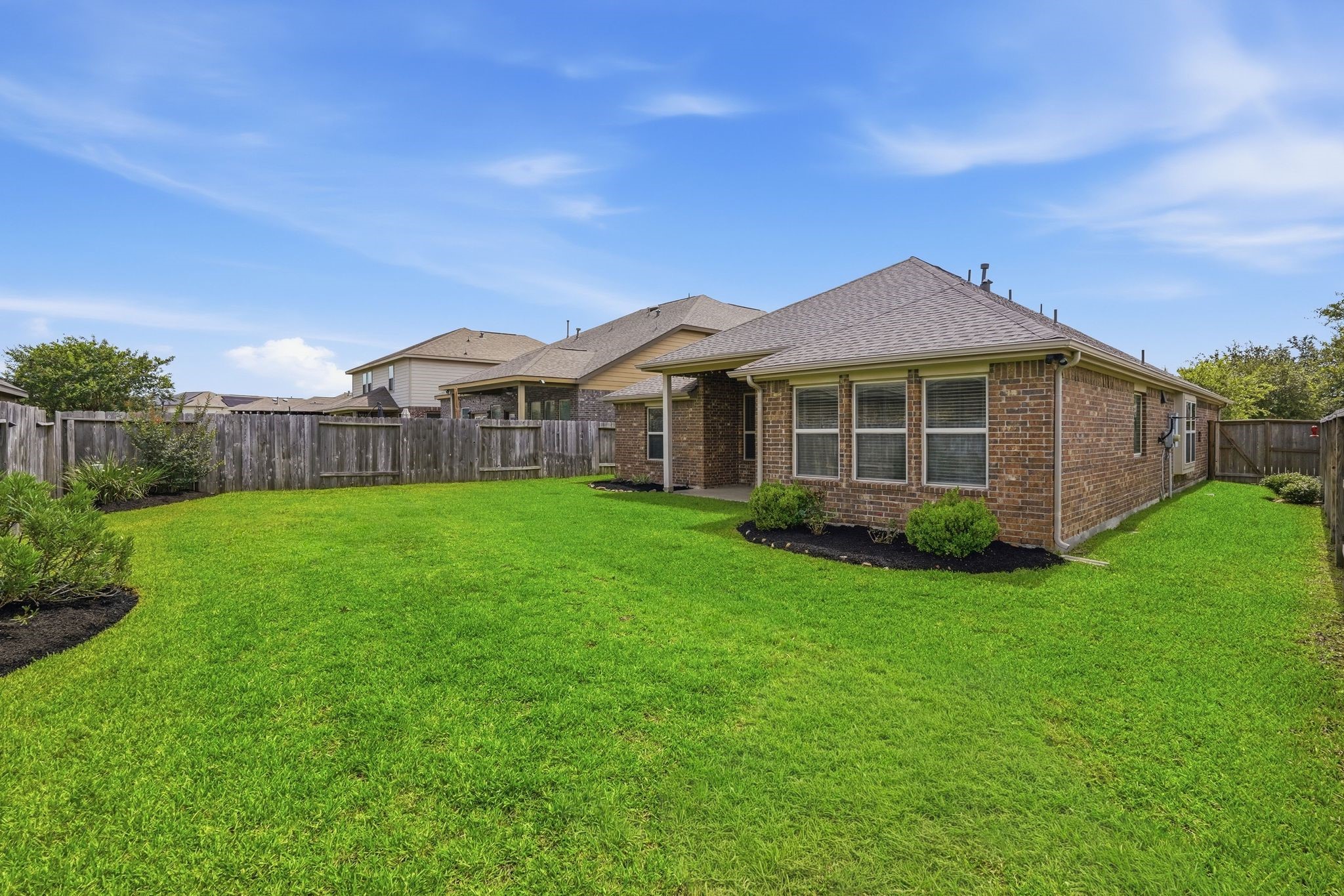 18227 Tacoma Ridge Drive Tomball, TX 77377 - Photo 37 of 45 Rear exterior showcasing the covered patio and beautifully maintained yard.