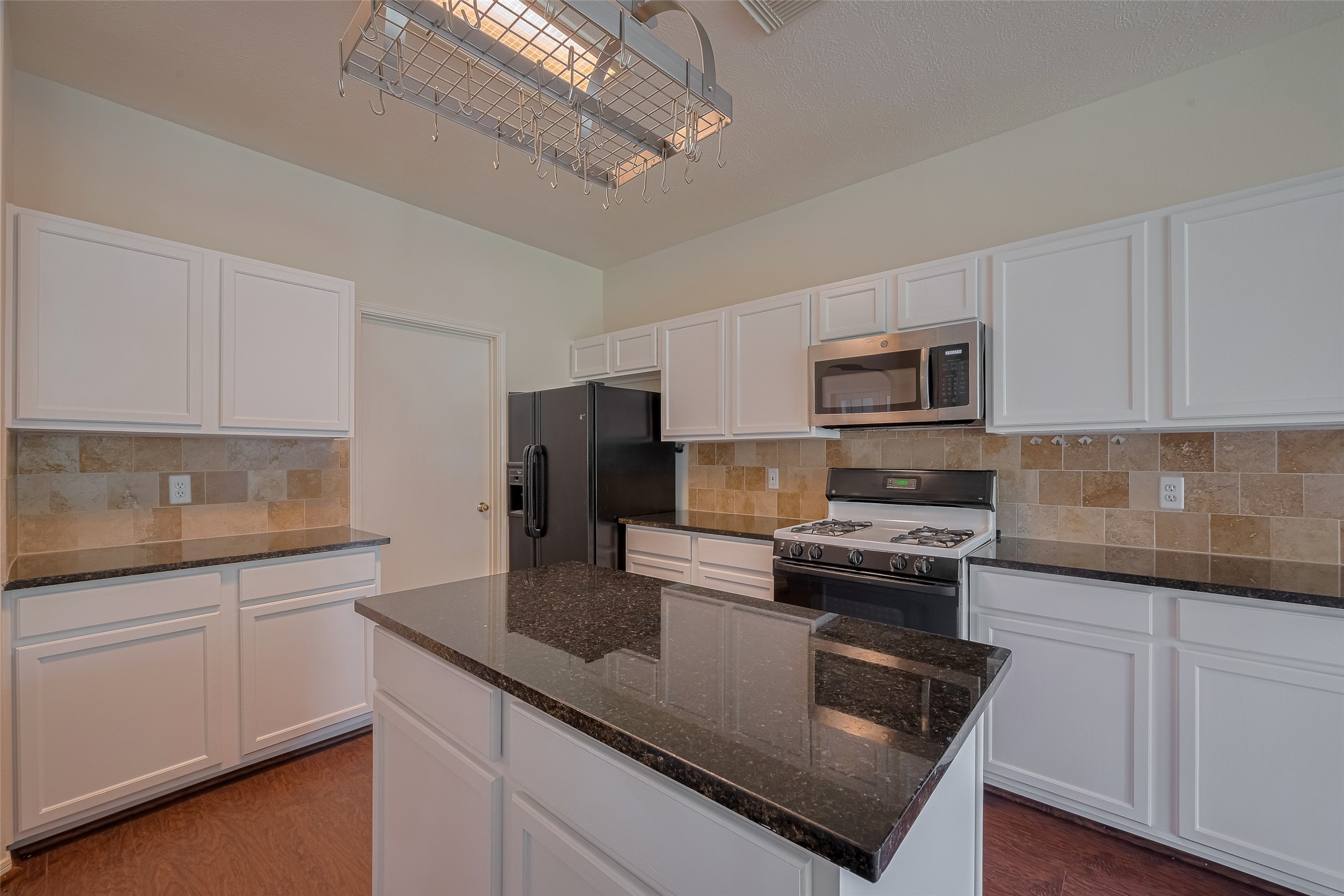 619 Bending Bough Drive Spring, TX 77388 - Photo 13 of 41 a kitchen with kitchen island granite countertop a sink stainless steel appliances and white cabinets