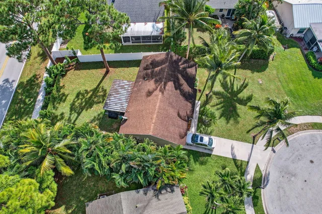 an aerial view of a house with a yard basket ball court and outdoor seating