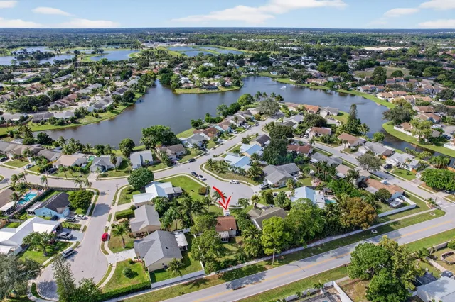 an aerial view of lake and residential houses with outdoor space