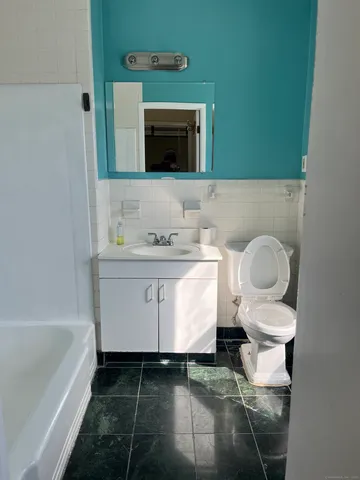 a bathroom with a sink toilet and mirror